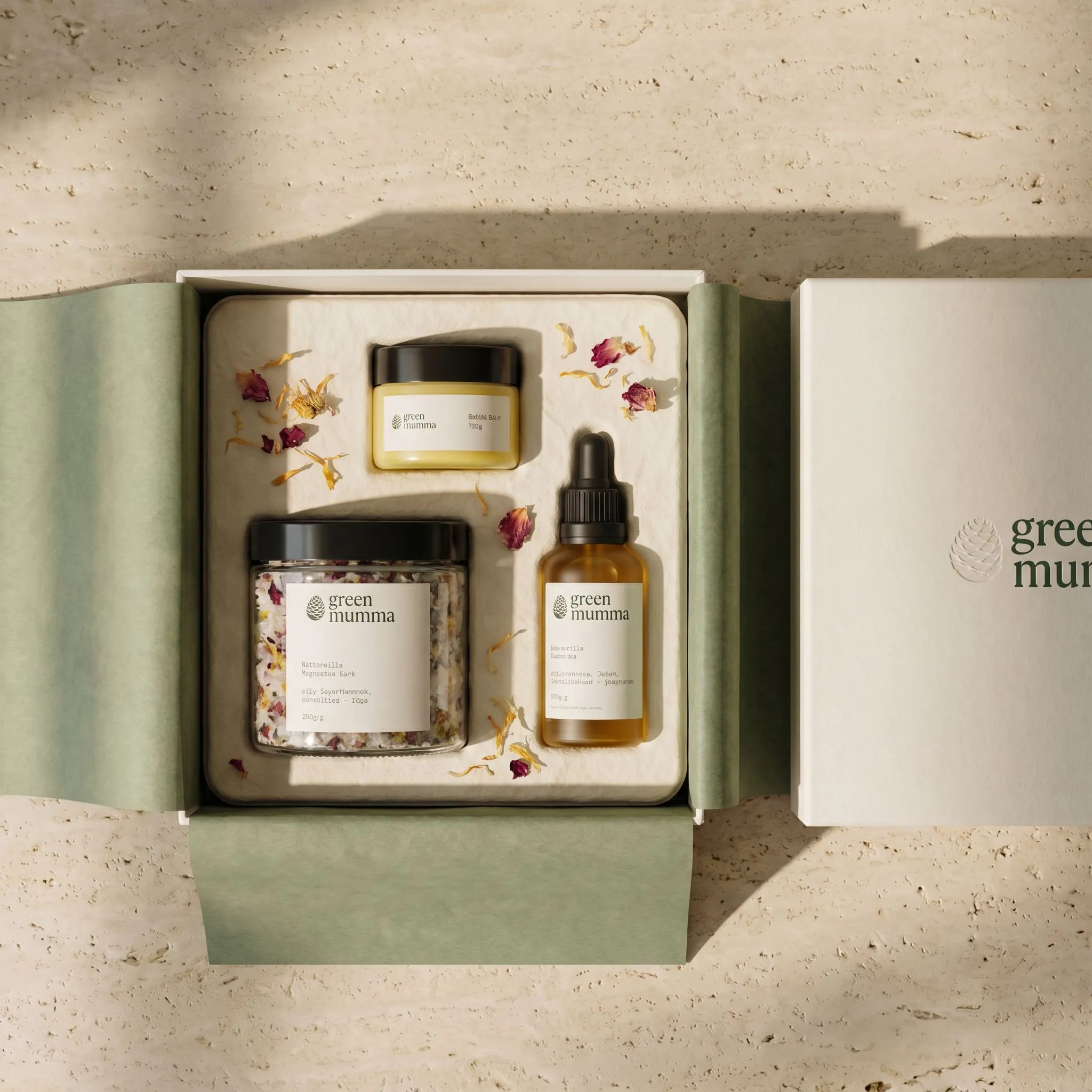 The Postpartum Ritual gift box flat lay with all three products and petals