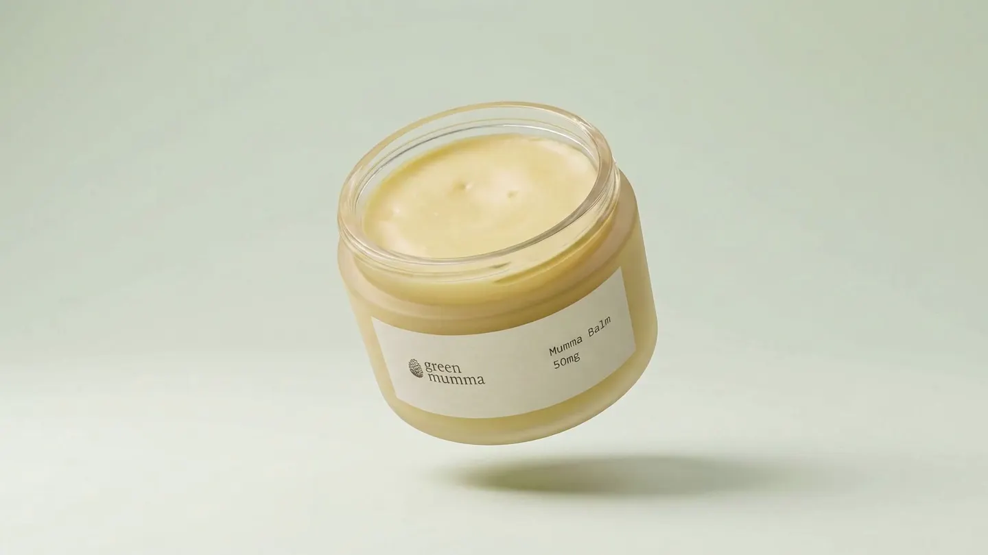 The open Mumma Balm jar tilted forward, showing the set balm inside